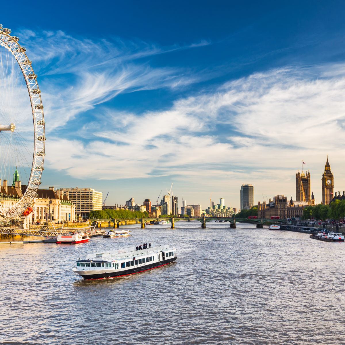 An image of Westminster in London, with the London Eye looking over the River Thames